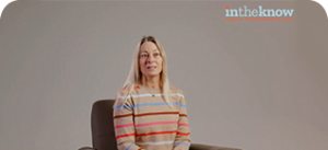 a woman with a striped shirt sitting in a chair