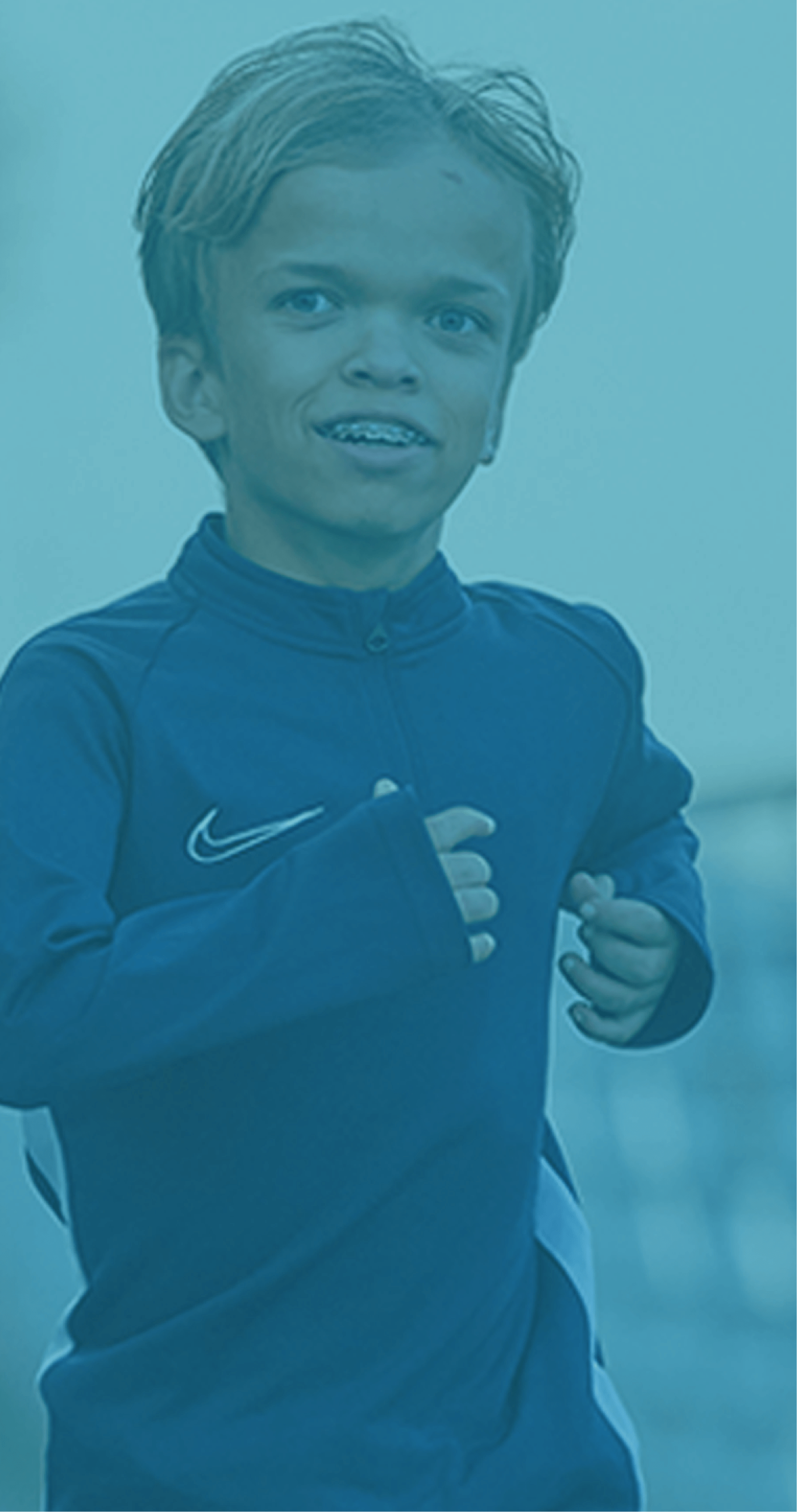a close up of a young boy with Achondroplasia wearing running clothes