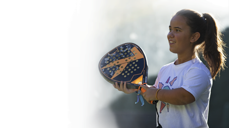 a young girl with Achondroplasia holding a tennis racket