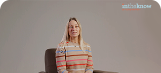 a woman with a striped shirt sitting in a chair