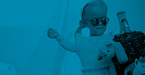a girl with Achondroplasia holding a purse and wearing sunglasses